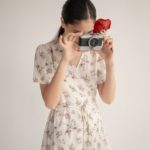 picture of a model holding camera