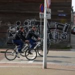 urban photography of police roaming around in bicycle